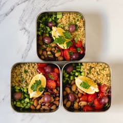 Mediterranean Quinoa Salad Bowl in metal meal prep containers