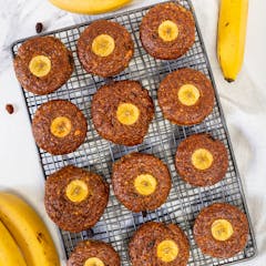 12 banana bread muffins on a 3 by 4 organisation on a tray cooling down