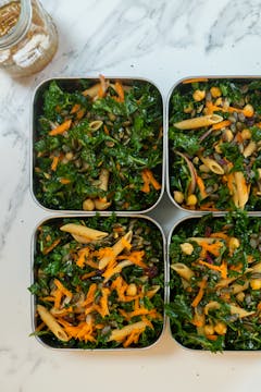 Meal Prep Kale Salad divided into meal prep containers.